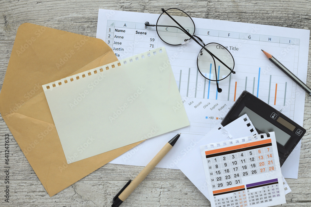 Poster top view of calendar and calculator and notepad with blank page, on wooden surface with pen