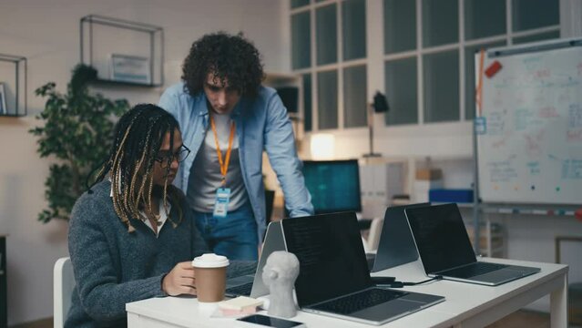 Displeased supervisor talking with newbie office worker, employee's mistake