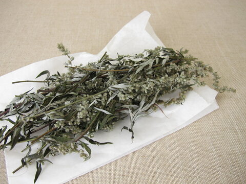 Dried mugwort and a white paper bag