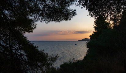 Fototapeta na wymiar Colourful dramatic sky with cloud at sunset at Aegean sea beach in Greece