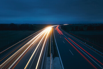 Busy highway in countryside at night. Themes car transportation, direction and connection.. - 641261458