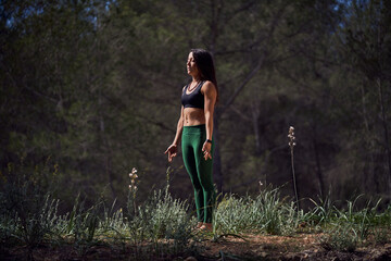 Fit ethnic woman standing in Tadasana pose during yoga practice