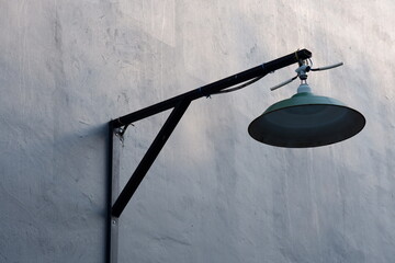 An old pendant lamp is installed in a house with gray walls