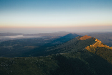 Pyramid shape shade of Rtanj mountain peak on sunrise	