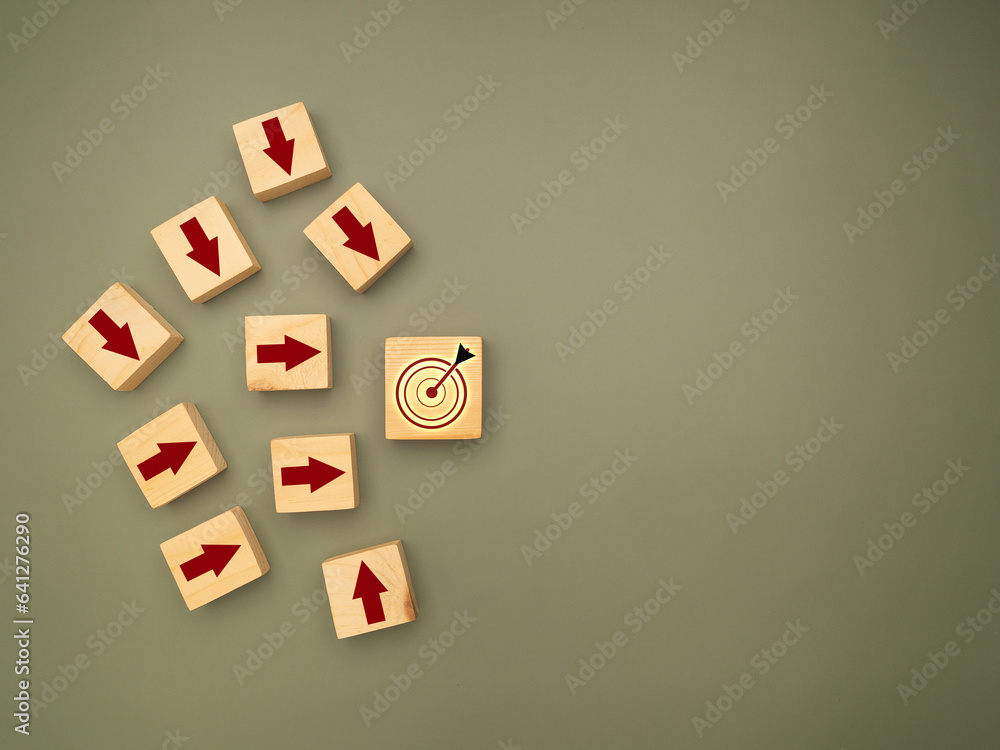 Poster wooden cubes with red arrows pointing to the dartboard icon are on a green background