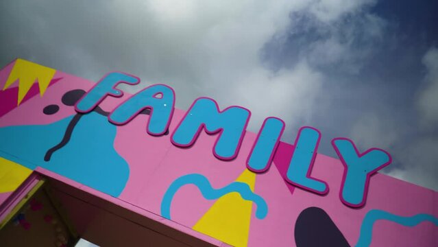 family sign in blue colour and pink outlines colourful background spinning 360 orbit camera movement creative childish kids area designated to play relax leave kids to be cared for nursery games