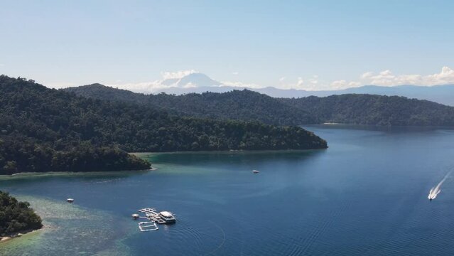 Aerial View Of Gaya Island With Mount Kinabalu In Background. Slow Push Forward, Ascending shot 