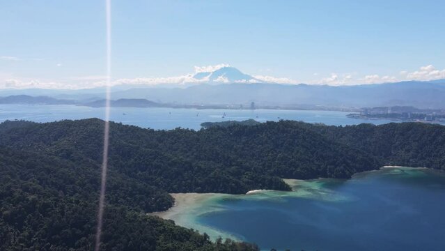 Aerial View Over Gaya Island With Mount Kinabalu In Background. Slow Parallax Shot