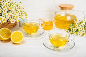 Herbal tea with fresh chamomile flowers on textured background. Calming and relaxing drink. Immunity.Cup of hot chamomile tea. Tea drinking concept. Tea ceremony. Place for text, copy space.