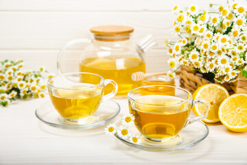 Herbal tea with fresh chamomile flowers on textured background. Calming and relaxing drink. Immunity.Cup of hot chamomile tea. Tea drinking concept. Tea ceremony. Place for text, copy space.