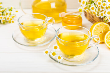 Herbal tea with fresh chamomile flowers on textured background. Calming and relaxing drink. Immunity.Cup of hot chamomile tea. Tea drinking concept. Tea ceremony. Place for text, copy space.