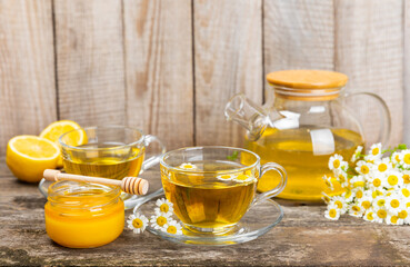 Herbal tea with fresh chamomile flowers on textured background. Calming and relaxing drink. Immunity.Cup of hot chamomile tea. Tea drinking concept. Tea ceremony. Place for text, copy space.