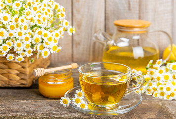 Herbal tea with fresh chamomile flowers on textured background. Calming and relaxing drink. Immunity.Cup of hot chamomile tea. Tea drinking concept. Tea ceremony. Place for text, copy space.