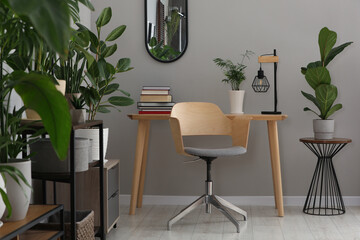 Cozy room interior with stylish furniture, houseplants and decor elements