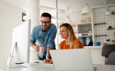 Portrait of success business people working together in home office. Couple teamwork startup concept