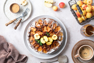 French sweet tarte tatin apple pie upside down and fresh red apple.