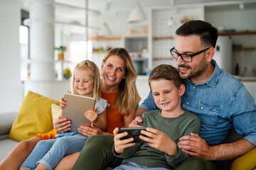 Device technology family online education concept. Happy family with digital devices at home.