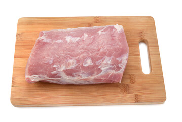 Wooden cutting board with a piece of raw pork meat on a white background.
