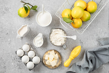 Ingredients for making a pie with lemon curd and blueberries on a white stone table.