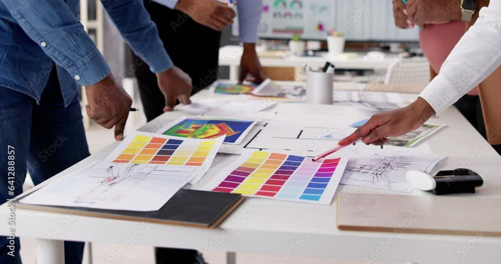 Poster designer group at desk discussing custom house