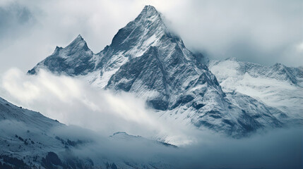 Obraz premium Majestic mountain peaks covered in a blanket of snow