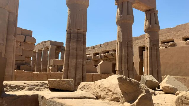 Karnac temple in Egypt. Smaller columns and ruins in a peripheral temple.  Pan right, sunny day.