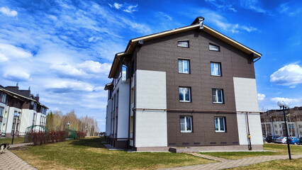 New house on the street in small village or town in a spring or atutumn day. Landscape with...