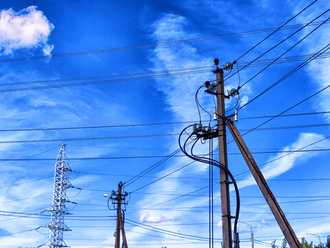 Old Power electric pole with limewire on blue sky with white clouds background. Photography consisting of power electric pole with lime wire. Line wire in power electric pole in nature