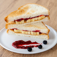 peanut butter and jelly sandwich with banana and fresh blueberry