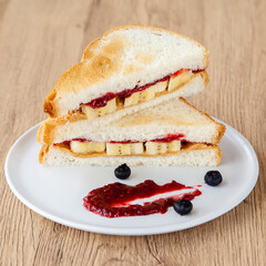 peanut butter and jelly sandwich with banana and fresh blueberry