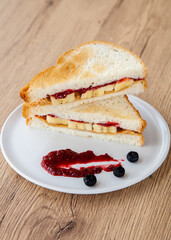 peanut butter and jelly sandwich with banana and fresh blueberry