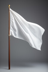 Closeup of a white flag waving on a flagpole against a gray background isolated , mockup