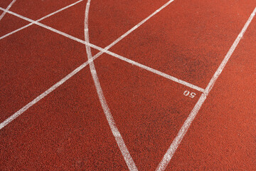 Running track surface with lanes and lines on a track and field athletics stadium. Sport running, jogging or walking runway.