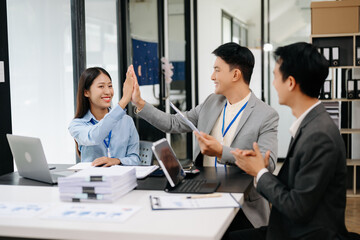 Group of Young Asian business team creative businesspeople coworker, teamwork celebrating achievement and in planning design in creative in office..