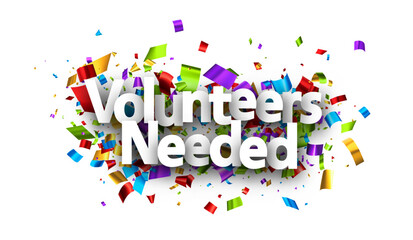 Volunteers needed sign over colorful cut out foil ribbon confetti background.