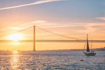 View of 25 de Abril Bridge famous tourist landmark of Lisbon connecting Lisboa and Almada over...