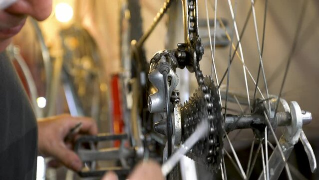 Bicycle mechanic in the workshop in the process of repair.