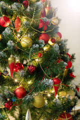 Red and golden baubles on christmas tree for background. New Year concept.