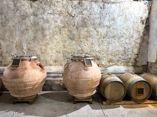 Clay pots and oak barrels for wine fermentation at a South African wine farm