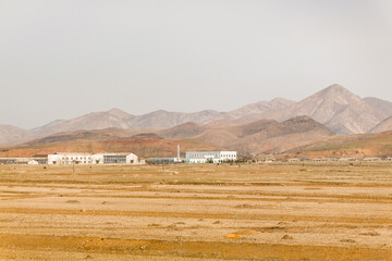 NORTH KOREA - MARCH 26, 2008: factory in barren countryside,  near a village, between Kaesong and Pyongyang, Democratic Peoples's Republic of Korea (DPRK)