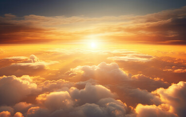 The sun rises over a clear sky with clouds