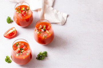 Spanish tomato and watermelon gazpacho cold soup styled and decorated in glasses
