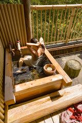 KUROKAWA ONSEN, JAPAN: having traditional Japanese bath on the balcony of her room