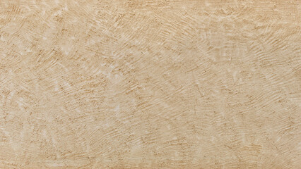 Background of a cement wall textured with abstract shapes and splashes, painted in cream or beige color