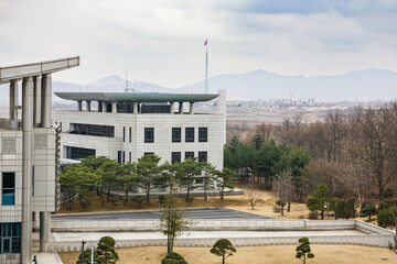 PANUMJUOM, NORTH KOREA: South Korean Freedom House building to the left, Peace House  in the center and Kijong village giant pole with North Korean flag in the background