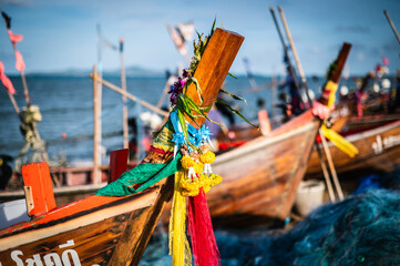 Flowers and three green, yellow and red cloths that local fishermen tie to beg for fish at the...