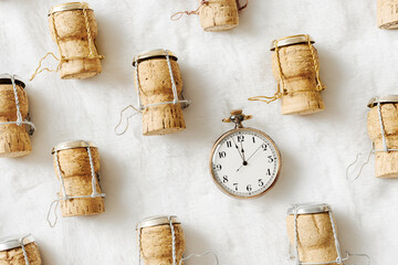 Happy New Year, xmas party concept, retro pocket watch and wine corks from festive champagne on...