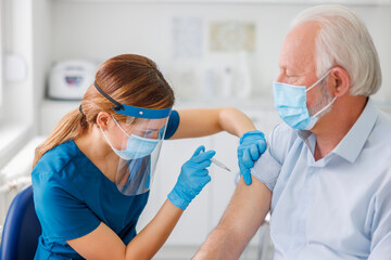 Senior man getting seasonal flu vaccine