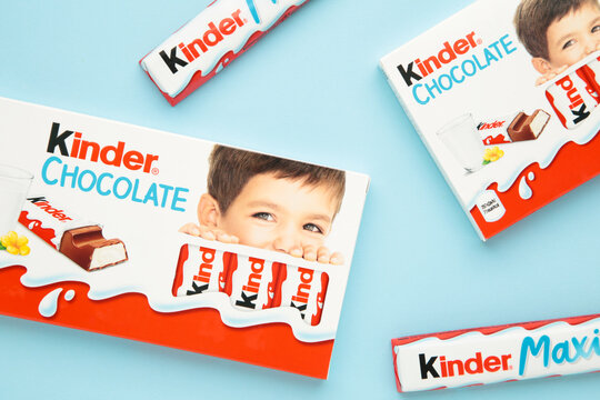 Mykolaiv, Ukraine - July 28, 2023: Kinder chocolate bars on blue background. Kinder bars are produced by Ferrero founded in 1946.