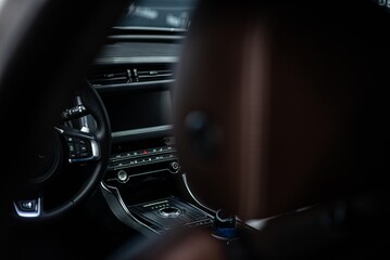 Interior of a modern luxury car with a multimedia panel and automatic climate control